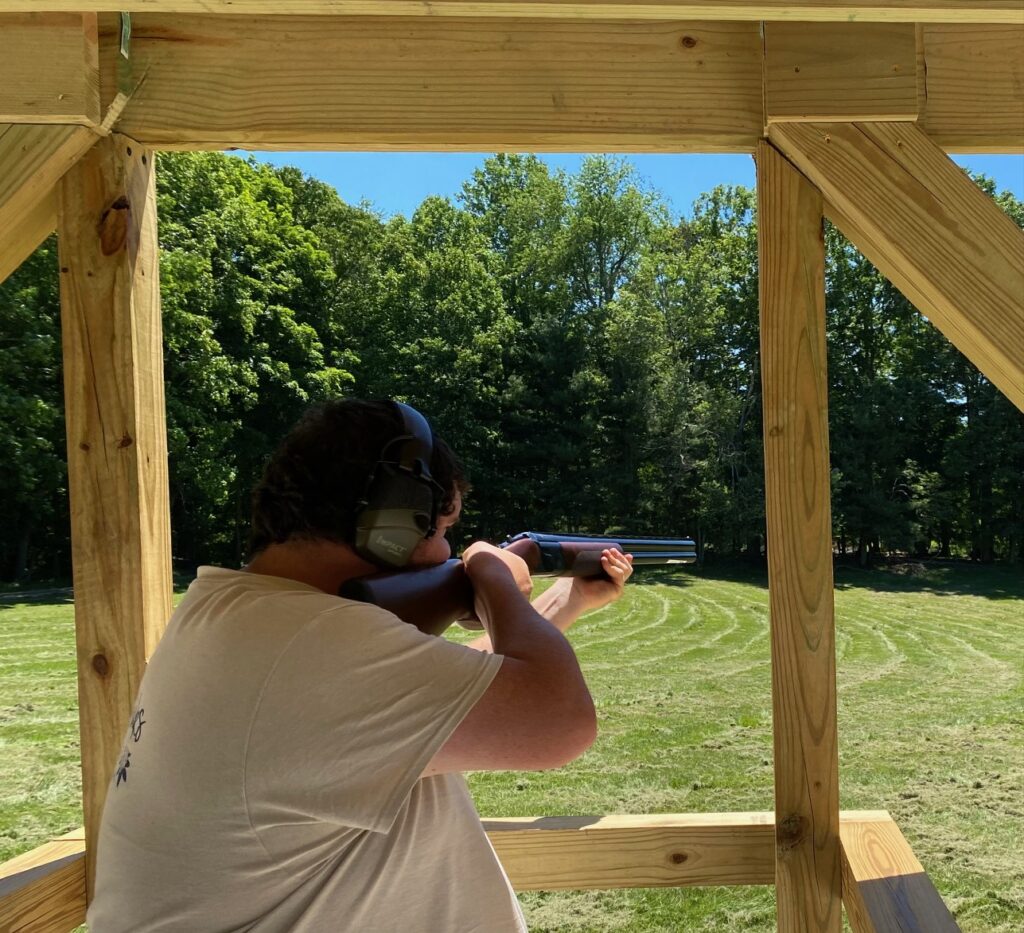 Man preparing to fire a shotgun at a Trap shooting range