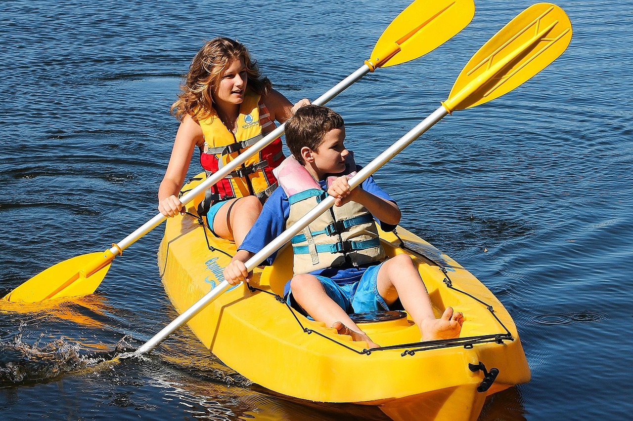 Two kids in a duckie kayak